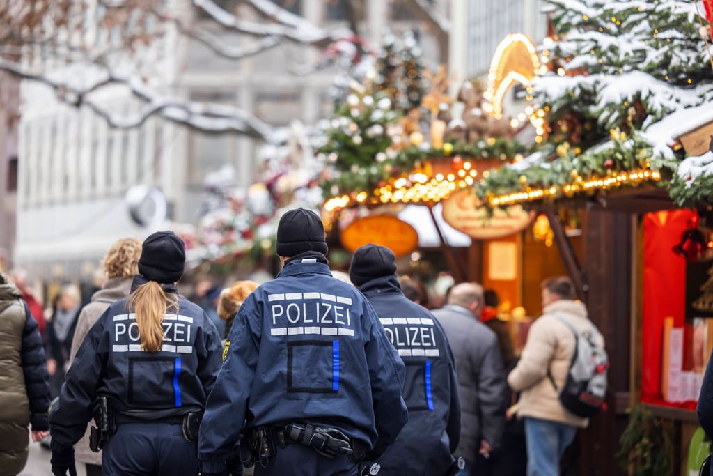 Polizisten auf Streife auf einem Weihnachtsmarkt.