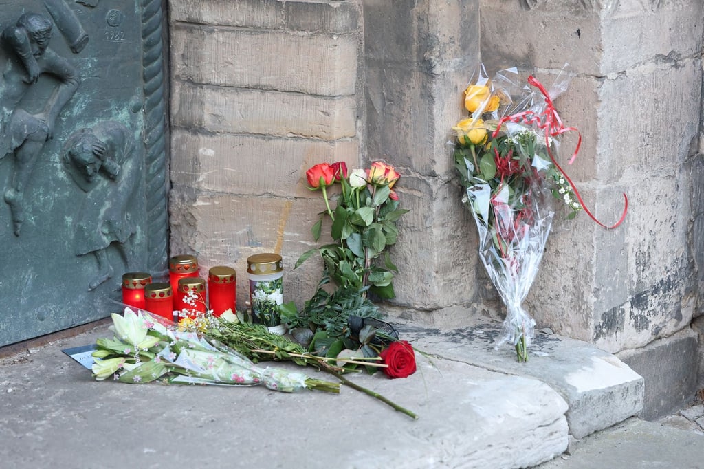 Kerzen und Blumen zum Gedenken an die Opfer, am Abend sollen Glocken geläutet werden.