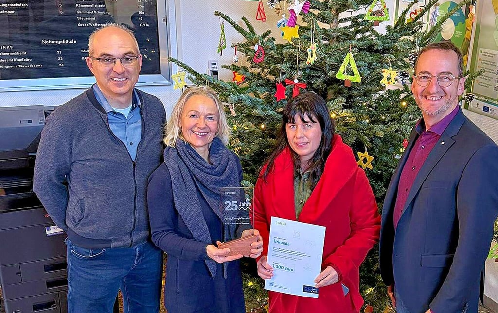 Nadine Schütte (zweite von rechts) und Kathrin Goyer mit der von Andreas Forke (rechts) überreichten Urkunde sowie dem Erinnerungsgeschenk, einem Pokal. Bürgermeister Norman Klebe freut sich für den Verein.
