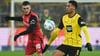 Leverkusens Florian Wirtz (l) blieb im Spiel bei Borussia Dortmund zunächst auf der Ersatzbank.