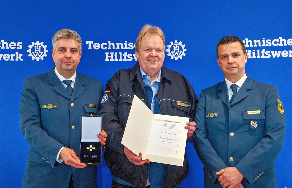 Der Weißenfelser Olaf-Hartwig Tewes (M.) wird vom THW-Landesbauftragten Sebastian Gold (l.) und Landessprecher Marcus Leinweber mit dem Ehrenabzeichen in Gold geehrt.