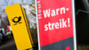 Ein Warnstreik-Schild bei einem Post-Standort, daneben ein Briefkasten - im Ringen um einen Tarifabschluss haben Tausende Postler erneut die Arbeit niedergelegt.