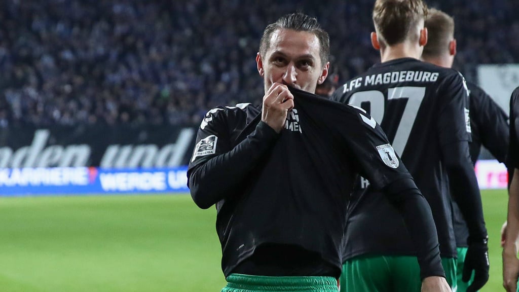 Baris Atik küsst das Wappen des 1. FC Magdeburg auf seinem Trikot.