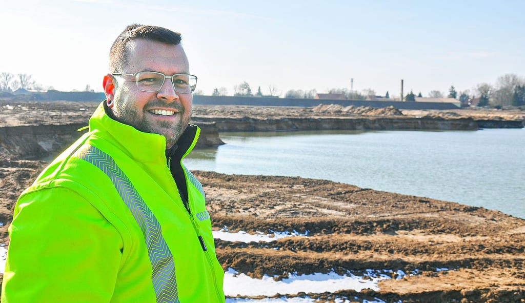 Aktuell eine Mondlandschaft: Nico Miethke von der Gilde GmbH steht an der neuen Kiesgrube Geestgottberg, im Hintergrund schließt sich direkt das Dorf an.