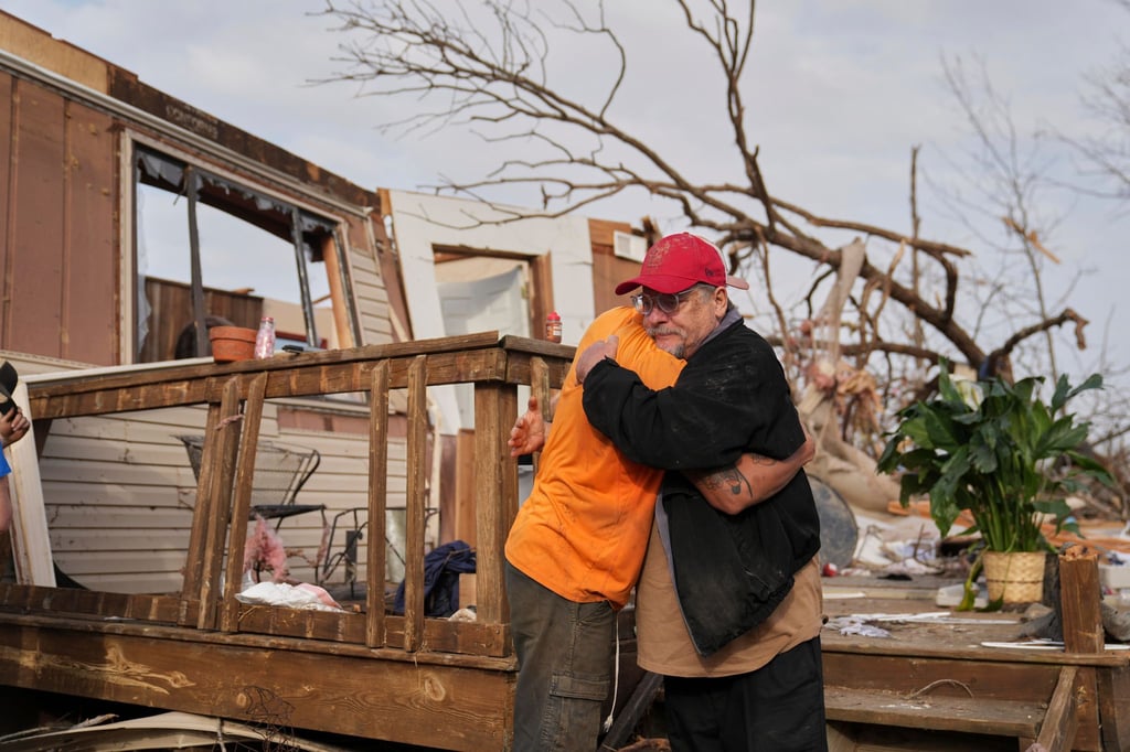 Nach dem Durchzug eines Tornados in Missouri spenden sich Freunde Trost und räumen auf.