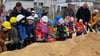 Harzgerodes Bürgermeister Marcus Weise gibt den Kindern der Kita "Regenbogenland" in Harzgerode einen kleinen Hinweis beim symbolischen ersten Spatenstich für das neue Schwimmbad.
