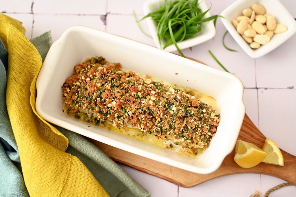 Der Crunch für diese Bärlauchkruste kommt von Mandeln und geröstetem Toast. Parmesan und Zitrone ergänzen die Würze des Bärlauchs.