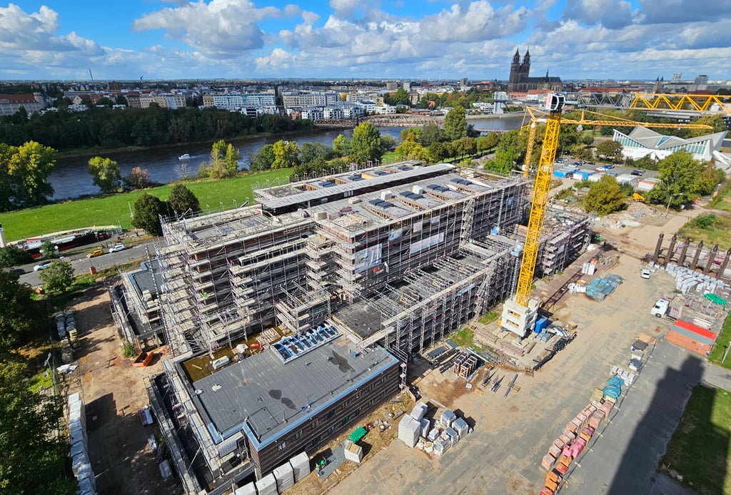 Blick auf die im Umbau befindliche Stadthalle Magdeburg. Sie soll spätestens 2027 fertig sein und mit der Hyparschale (Hintergrund) ein Ort für Kultur, aber auch für Tagungen werden.