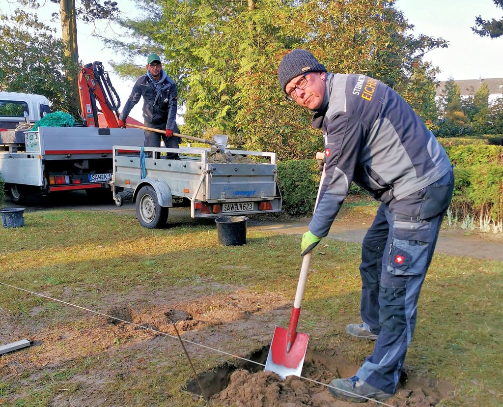 Reiner  Schaluppa (r.) und  Alf Ziegler bereiten das Aufstellen der Stele auf dem Kalbenser Friedhof vor.