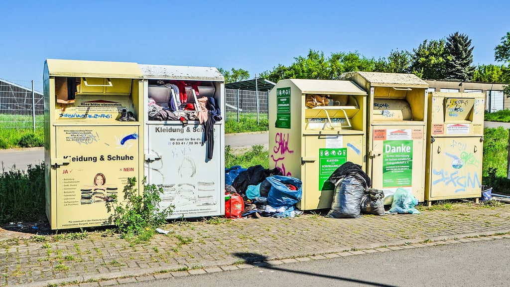 Die Altkleidercontainer im Wanzleber Stadtgebiet sind fast alle überfüllt und Säcke stapeln sich davor.