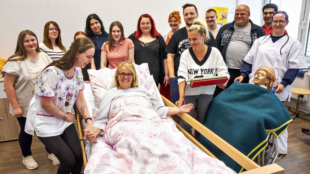 Pflegeausbilderin Annett Klepsch lässt sich von ihren Schülern versorgen. Die Azubis sind zwischen 18 und 45 Jahre alt.