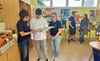 Schulleiterin Andrea Bunda (l.) und  Lehrerin Luisa Just lassen sich von Schüler Cederic Kolbe die Arbeit in der Lernwerkstatt erläutern. 