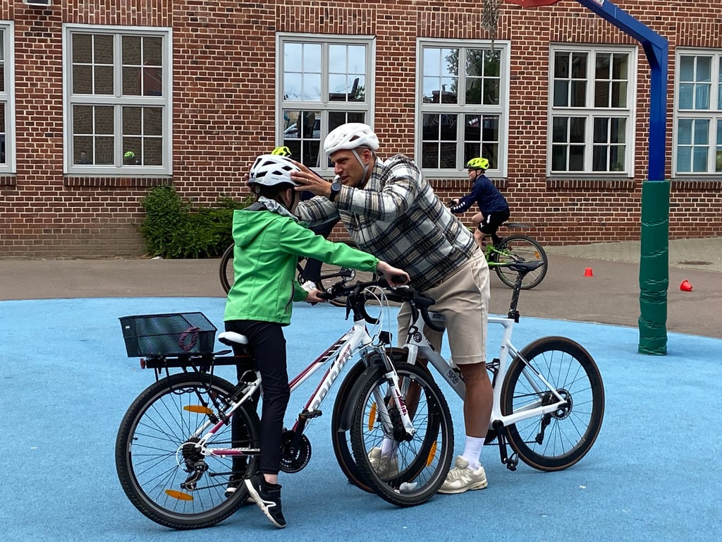Sitzt der Helm auch richtig? Marcel Kittel gibt bei seinem Besuch den Schülerinnen und Schülern praktische Tipps zum Radfahren.