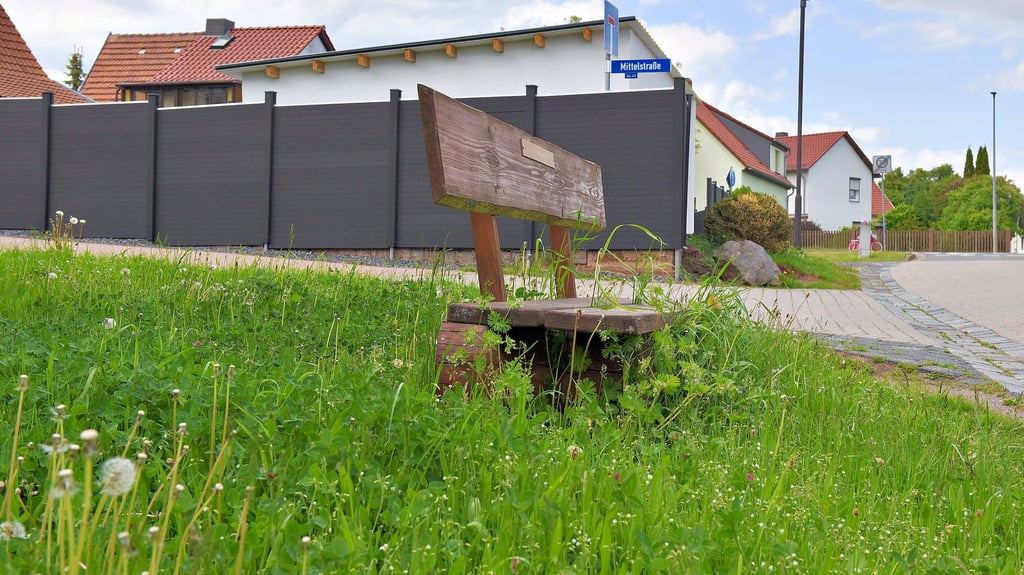 Komplett zugewachsen – eine Bank auf einer Grünfläche in der Mittelstraße in Annarode.