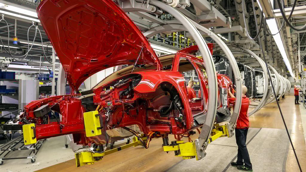 Ein Mitarbeiter montiert Kabelbäume an einen Porsche Panamera. Künftig fällt eine Schicht in der Montage weg.