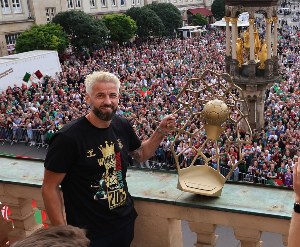 SCM-Coach Bennet Wiegert genießt nach dem Gewinn der Champions League mit neuer Frisur und gekürztem Bart die Stimmung bei der Siegesfeier mit den Fans auf dem Alten Markt.
