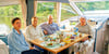 Das Ehepaar Brigitte (von links) und Axel Hofmann aus Frankfurt/Main, ein guter Freund und Hafenmeisterin Sigrid Weidenbach kommen in Havelberg  beim Frühstück an Bord der Yacht „Dancing Green“ ins Gespräch. 