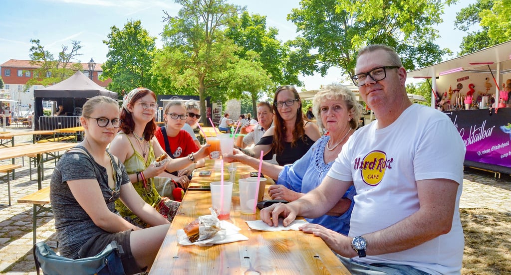 Besucher des Oschersleber Stadtfestes lassen es sich in einem schattigen Plätzchen vor der Bühne am Hackelberg gut gehen.