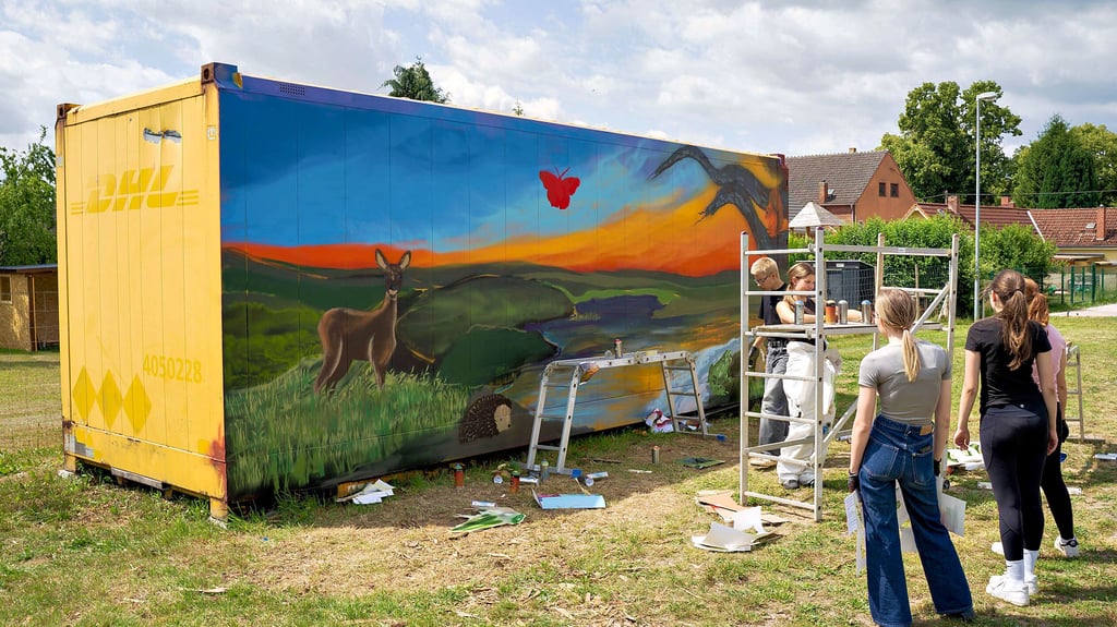 Die Schüler begutachten den Zwischenstand ihres Graffiti-Projekts am Festplatz in Rahnsdorf.