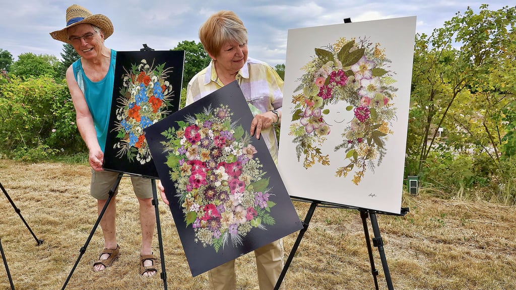 Angela und Dieter Straßberger bauen ihre Blütenbilder für „Rose trifft Kunst“ im Europa-Rosarium auf.