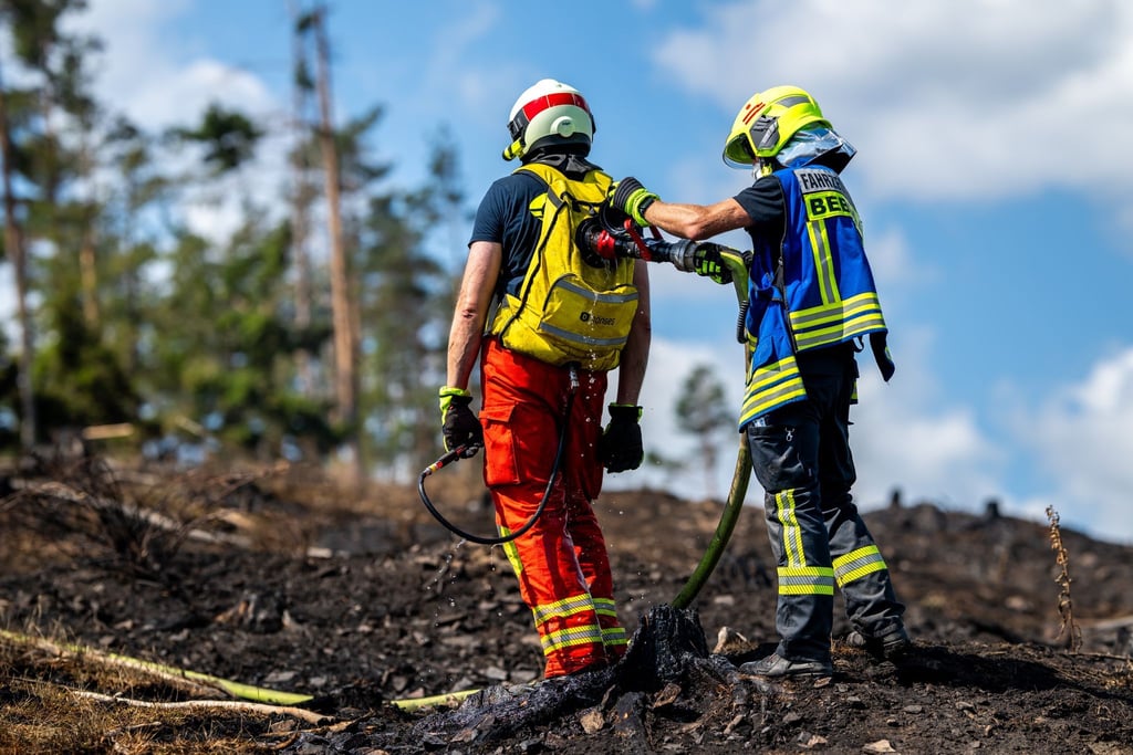 Mit Löschrucksäcken gehen die Feuerwehrleute etwa gegen Glutnester vor.