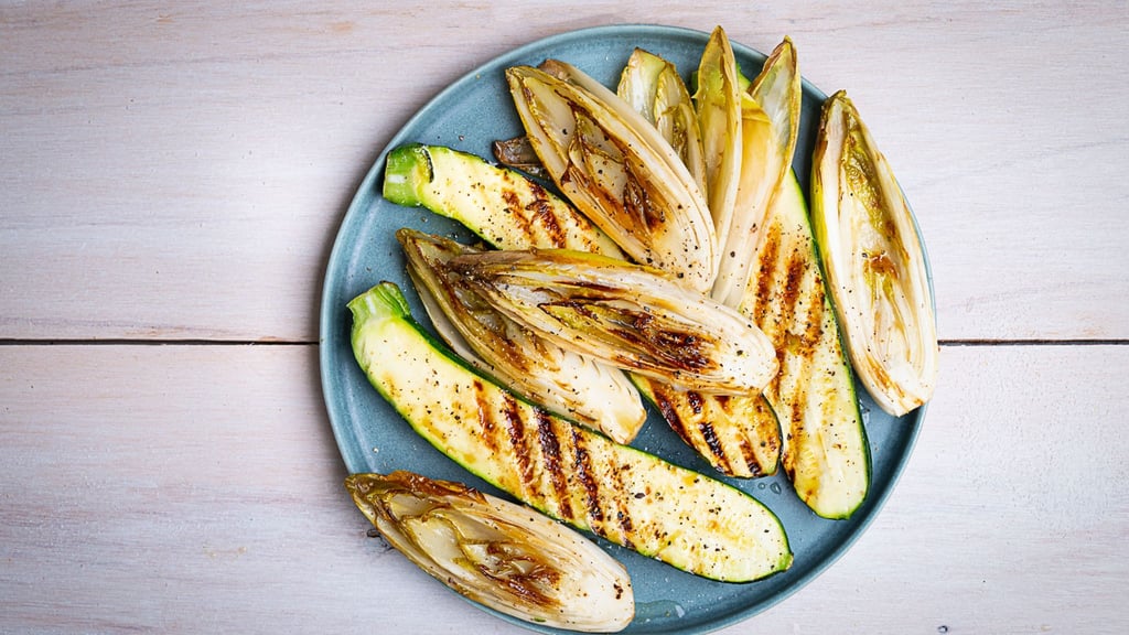 Die länglich geschnittenen Zucchini- und Chicorée-Streifen werden mit einer Marinade aus Olivenöl, Limettensaft, Salz und Pfeffer eingepinselt, dann auf jeder Seite 2–3 Minuten gegrillt.