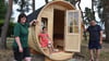 Nicole und Alexander Albrecht zeigen gemeinsam mit Nichte Sophie stolz das neue hölzerne Fass auf ihrem Naturcampingplatz in Wassensdorf. Es steht direkt an der Badekuhle.