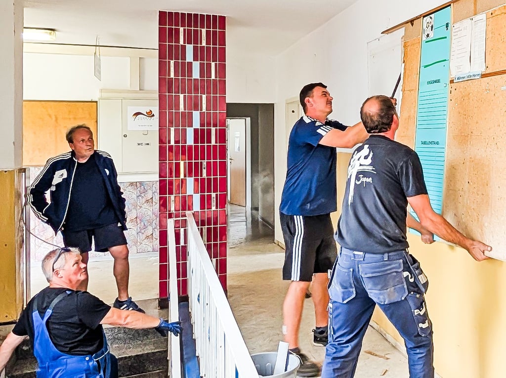 Gerd Möbius, Heiko Buchmann, Robin Wilke und André Kulas (v.l.n.r.) beim ersten Arbeitseinsatz. Nicht alles wird „kurz und klein“ gemacht, ein Teil der historischen Kork-Pinnwand findet ein Plätzchen im sanierten Flur.