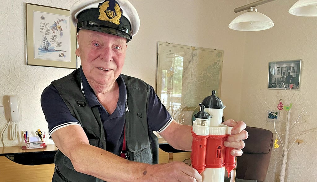 Helmut Schiel aus Bittkau, Hochseekapitän und Fischhändler aus Leidenschaft, mit seiner letzten Uniformmütze und einem seiner selbst gedruckten Leuchttürme.