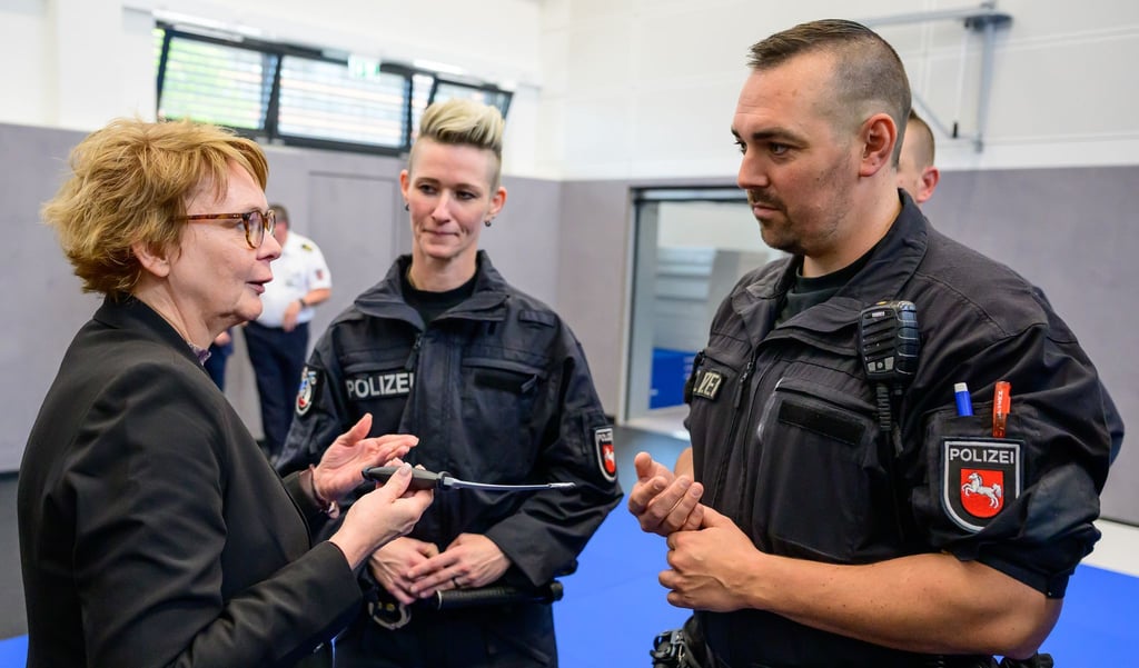 Daniela Behrens (links, SPD), Innenministerin Niedersachsen, spricht mit Polizisten kurz nach einem Einsatztraining.