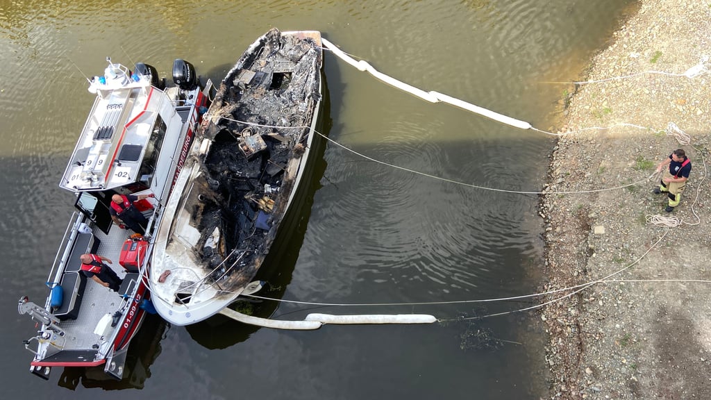 Nach dem Brand einer Yacht in der Zollelbe in Magdeburg steht die Bergung noch aus. Die Eigentümer aus Dänemark sind nicht erreichbar.
