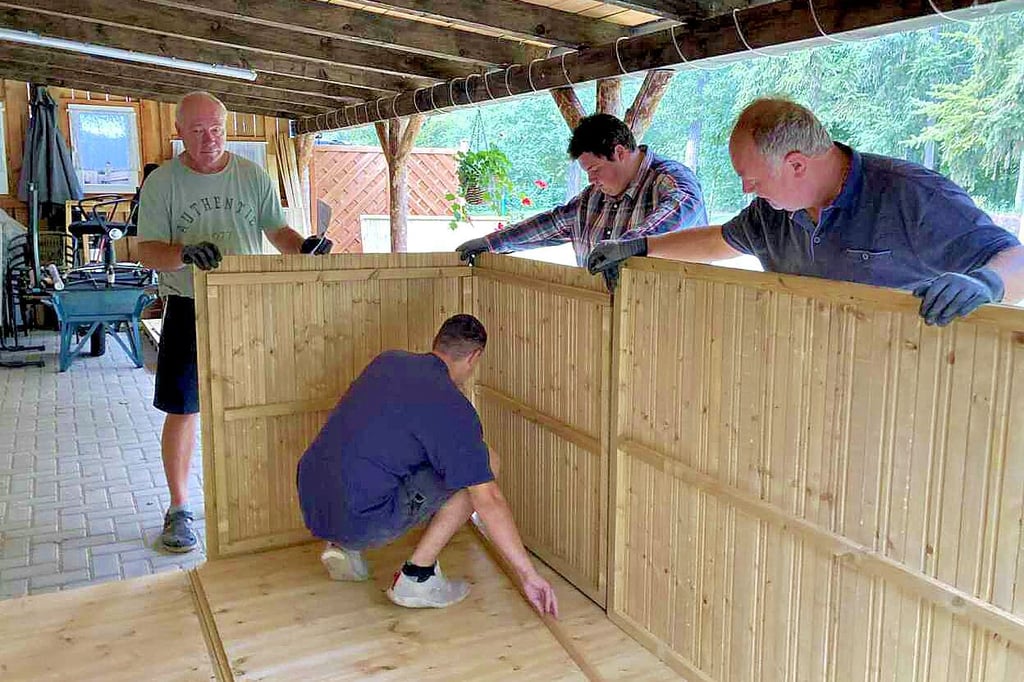 Die Pächter Mario Kempe (rechts) und Bernd Bruder (links) bauen mit Helfern eine Hütte für den Froser See auf.