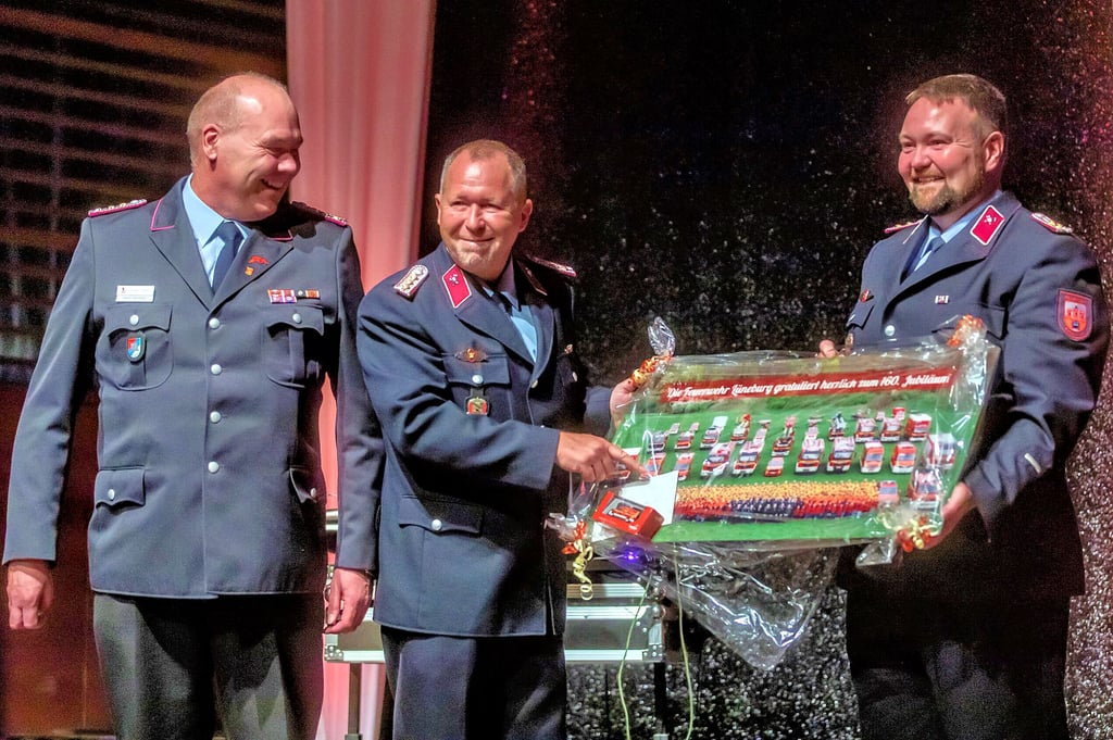 Lüneburgs Stadtbrandmeister Rainer Utermöhlen überreicht Ortswehrleiter Yves Kluge und seinem Stellvertreter Daniel Wagner (v.l.) ein Präsent.
