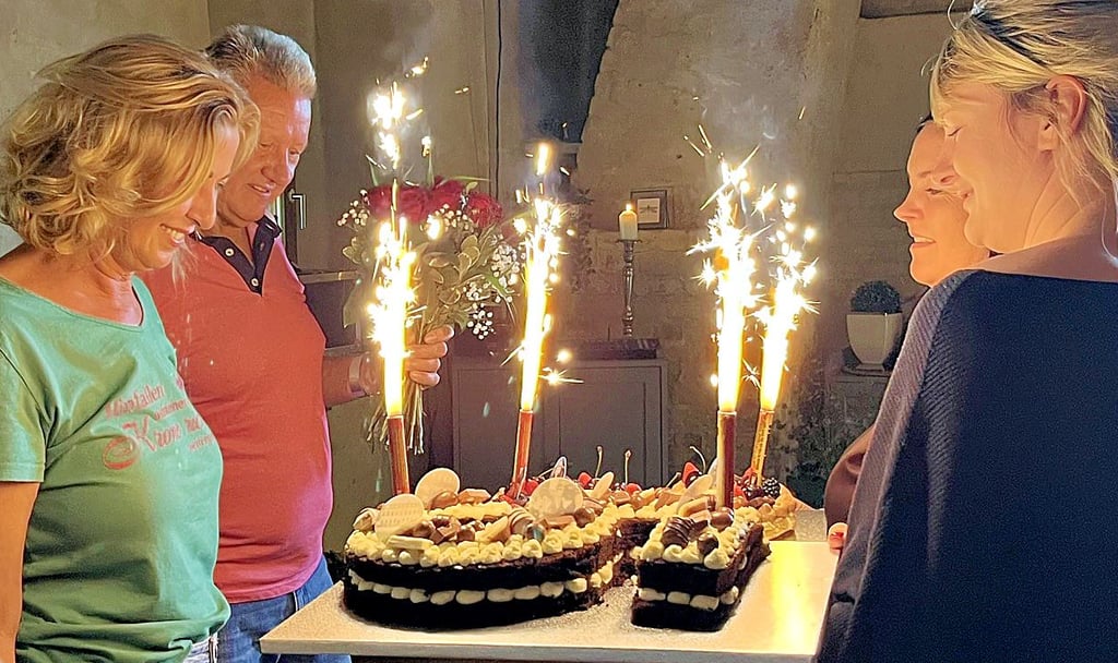 Die Überraschungs-Geburtstagstorte für Melanie Busse (links) und ihren Mann Wolfgang Krabbe – überreicht von langjährigen Mitarbeiterinnen.