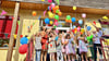 Zur Eröffnung steigen bunte Luftballons in den blauen Sommerhimmel.