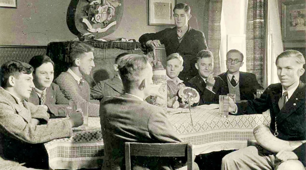 Schüler sitzen im Vereinszimmer des Schülerturnvereins Friesen. Die Bild entstand um 1930.