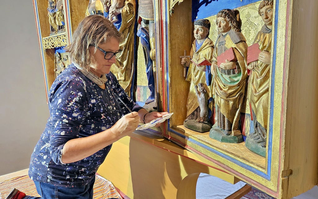 Restauratorin Angela Günther arbeitet am Schnitzaltar in der Kirche von Großbadegast und ist nicht zum ersten Mal hier.