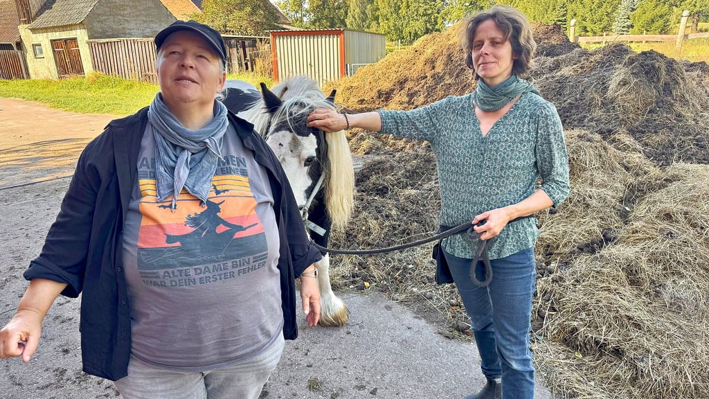 Kirsten Bruchhäuser (links) und Sandra Eckensberger erklären beim Rundgang über den Reithof in Meuselko den Inhalt der einzelnen Thesen.