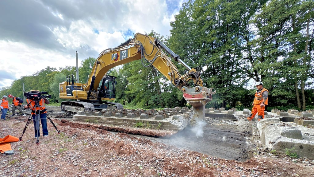 Ein Bagger hebt die die zwölf Tonnen schwere Betonplatte an, um sie für den Abtransport vorzubereiten.