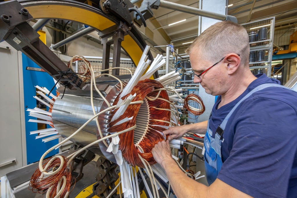 Damit wird mal eine Pumpe angetrieben: Elektromotorenbauer Rocco Hahne baut eine Spule für einen Elektromotor ein.