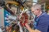 Damit wird mal eine Pumpe angetrieben: Elektromotorenbauer Rocco Hahne baut eine Spule für einen Elektromotor ein.