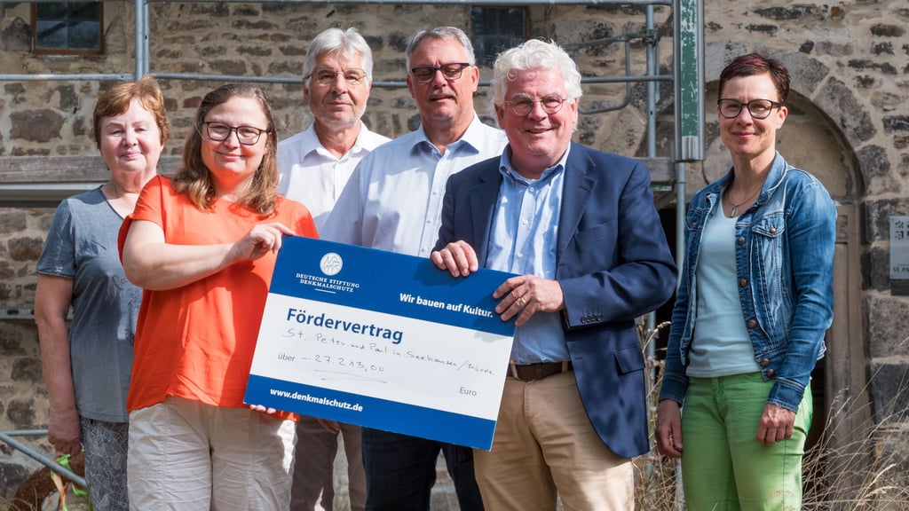 Direkt am Turm der Paulskirche in Seehausen haben die Vertreter der Deutschen Stiftung Denkmalschutz den Scheck über die Fördersumme übergeben.