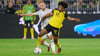 Bundesliga-Debüt in Dortmund: Wolfsburgs neuer Star Christian Eriksen (l) im Zweikampf mit Dortmunds Karim Adeyemi.