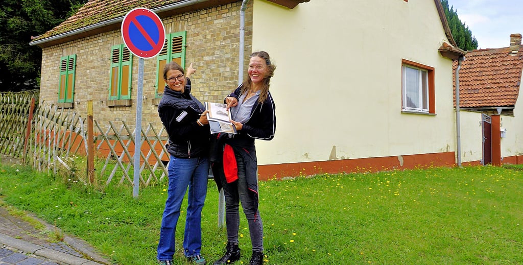 Franziska Knoll (links) und Sina Schönefuß vor einem Haus in der Rudolf-Breitscheid-Siedlung, das fast noch im Urzustand der Erbauung im Jahr 1921 ist. Die Ziegel an der Seitenfront dienen zur Verblendung und als Wetterschutz