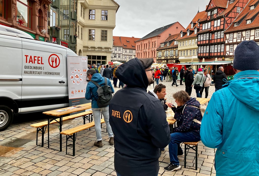 Mitarbeiter der Harzer Tafeln suchen auf dem Markt in Quedlinburg das Gespräch mit Passanten und laden zu einer Schale Suppe ein.