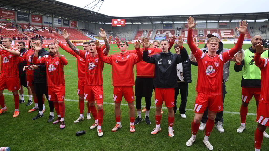 Die durchnässten HFC-Spieler feiern das 1:0 gegen den ZFC Meuselwitz.