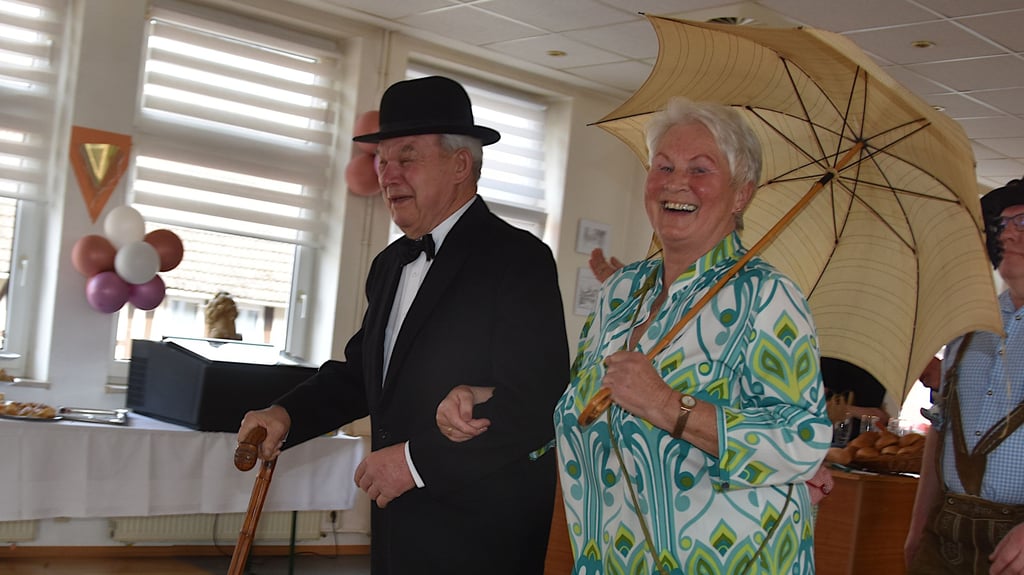 Mit Charme und Stil: Günter Baake präsentierte bei der Modenschau im Frühjahr einen eleganten Anzug aus vergangenen Zeiten, während Heidemarie Schweickert mit einem fröhlich-bunten Ensemble im Retro-Look und passendem Schirm einen modernen Kontrast setzte.