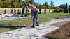 Hans-Peter Gerhardt verteilt Sand beim Parkseminar auf Schloss Hundisburg.