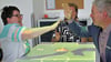 Die Schloß Hoym Stiftung hat nun eine Tovertafel – eine Art digitalen Spieltisch. Bewohnerin Bianca Mecke spielt zur Einweihung gemeinsam mit Sparkassenmitarbeiter Stefan König.