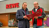 Projektentwickler Michael Hampel und Polier Frank Preuß vor dem neuen Rewe in Merseburg an der B181.